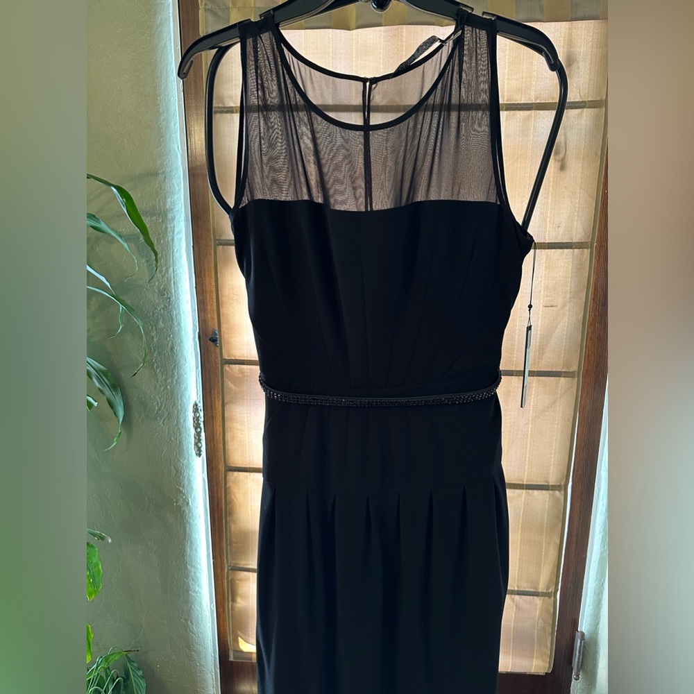 Black dress for any occasion. Has sheer top and beaded belt.
